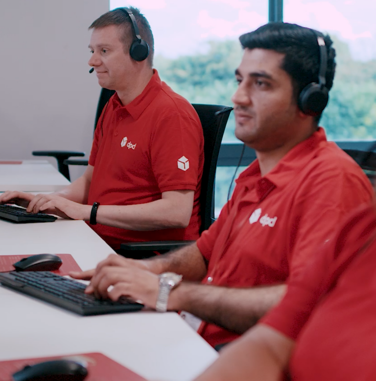 Three DPD customer service agents working at desk