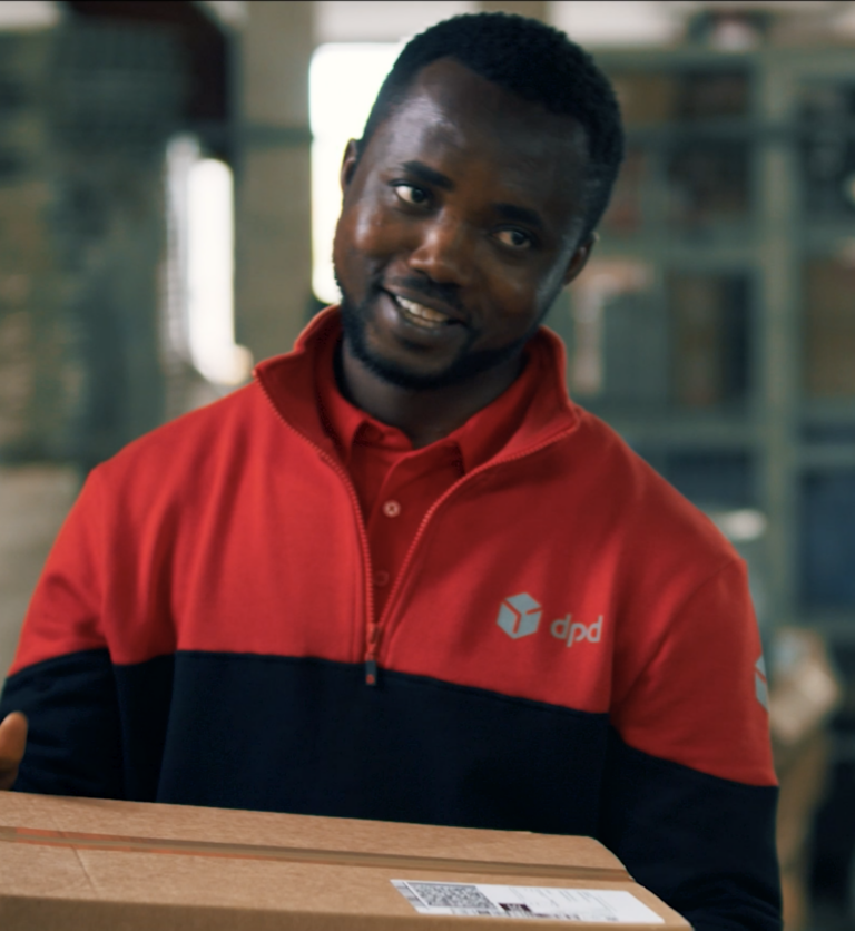 DPD warehouse worker with parcel in his hand